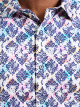 Close-up of a patterned shirt with blue, pink, and white design.