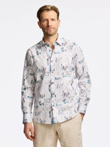 Man wearing a patterned shirt on a plain background