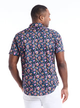 Man wearing a floral short-sleeve shirt on a white background