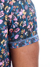 Colorful floral-patterned shorts on a person against a white background