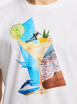 White t-shirt with a colorful graphic of a cocktail, beach scene, and jetskis.