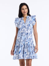 Woman wearing a blue floral dress on a white background