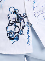 Embroidered design of a person on a motorcycle with text on a white fabric background