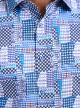 Close-up of a blue and white checkered shirt with a patchwork pattern.