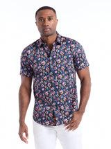 Man wearing a floral short-sleeve shirt on a white background