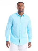 Man wearing a light blue button-up shirt on a white background