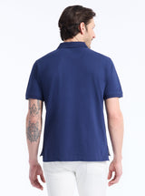 Man wearing a blue polo shirt on a white background