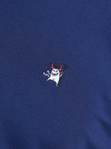 Embroidered devil logo on a blue fabric background