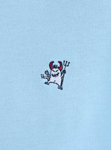 Embroidered devil design on a light blue fabric background